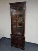 A Jaycee furniture carved oak leaded glass door corner unit