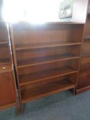 A mid century teak open bookshelf on raised legs