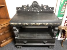 A two tier buffet stand fitted with a drawer on bun feet