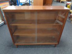 A mid century sliding glazed door bookcase