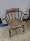 An Edwardian elm and beech smoker's armchair