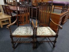 A pair of oak barley twist armchairs.