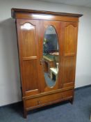 An Edwardian inlaid mahogany mirror door wardrobe