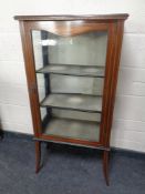 A 19th century inlaid mahogany display cabinet on raised legs