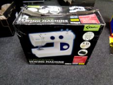 A boxed Delta Essentials 24 programme sewing machine