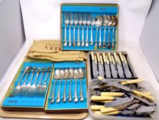 A tray of plated and stainless steel flatware