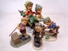 A Goebel figure group 'Tree Trimming Time' together with three further Goebel figures