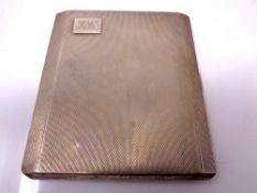 A silver cigarette case with engine turned decoration together with a silver heart shaped bookmark