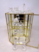 A quantity of Swarovski style crystal animal ornaments together with a glazed display cabinet