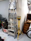 Two sets of aluminium folding ladders together with a site light on stand CONDITION