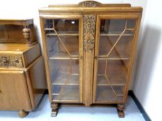 A 1930's carved oak glazed bookcase