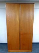 A 20th century teak double door wardrobe