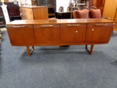 A mid century teak Long John cocktail sideboard