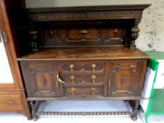 An Edwardian oak buffet backed sideboard on barley twist legs