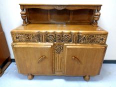 A 1930's carved oak buffet backed sideboard