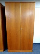 A 20th century teak double door wardrobe