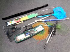 An antique tin deed box containing fishing rods, fishing sets, landing nets,