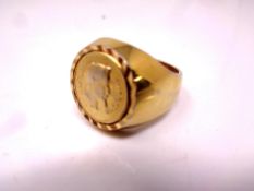 A gent's gilt metal coin ring.