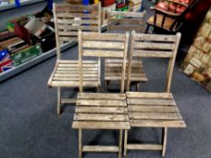 Four folding teak garden chairs