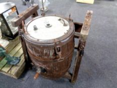 An oak coopered whisky barrel on stand