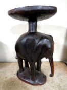 A carved hardwood occasional table on elephant base