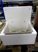 A Belfast porcelain sink with splash back