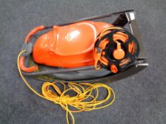 A Flymo Easi glide 330 electric mower with grass box and lead together with further extension lead