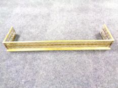 A Victorian brass fret work fender.