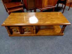 An American style two tier coffee table fitted a cupboard in oak finish
