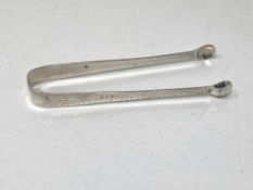 A pair of silver sugar tongs