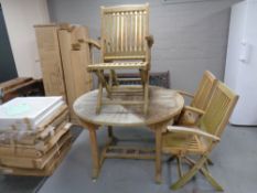 a teak garden table and four chairs. CONDITION REPORT: This is not antique.