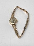 A lady's 9ct gold wrist watch on metal bracelet