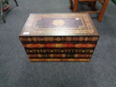 A storage box in the form of a large stack of books.