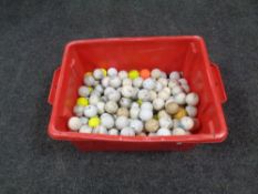 Two large boxes of golf balls.