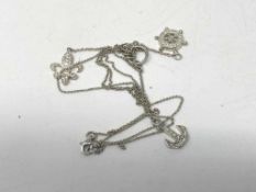 A silver pendant on chain