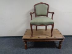 A contemporary armchair together with a colonial style coffee table.