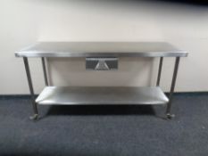 A stainless steel two tier preparation table.
