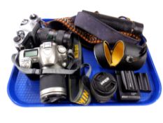 A Pentax Spotmatic camera together with a Nikon D50 camera together with battery charger and Nikon