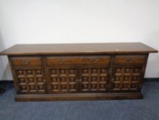 An oak dining room suite comprising of long sideboard and extending refectory style table and six