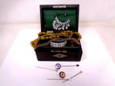 An antique jewellery box containing costume jewellery,