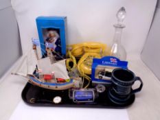 A tray of mid century telephone, crystal paperweight, boat figure,