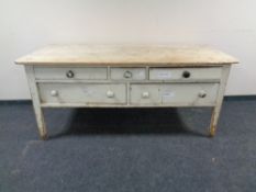 A Victorian pine table fitted with drawers.