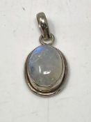 A silver stone set pendant