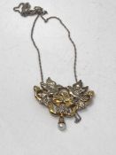 A silver pendant on chain