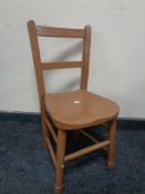 A small painted child's wooden chair together with a fishing rod with two reels and a camp bed