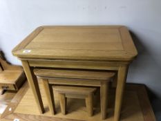 A nest of contemporary light oak tables.