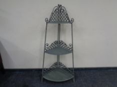 A metal three tier corner stand.
