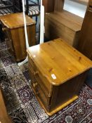 A pair of pine three drawer bedside cabinets.