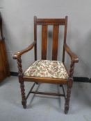 An Edwardian oak armchair.