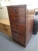 A reproduction mahogany filing cabinet.